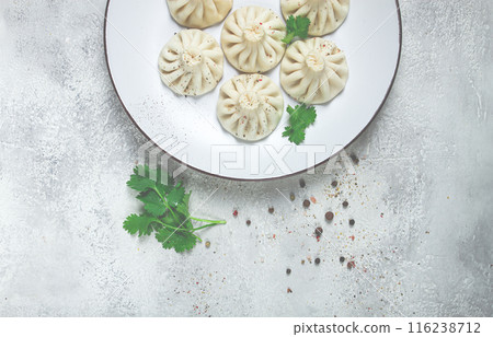 Khinkali, a traditional Georgian dish, with spices and herbs, on a white plate, top view, no people, Khinkali, a traditional Georgian dish, with spices and herbs, on a white plate, top view, no people, 116238712