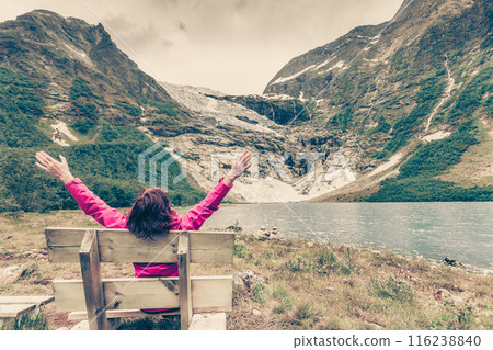 Tourist admiring Boyabreen Glacier in Norway 116238840