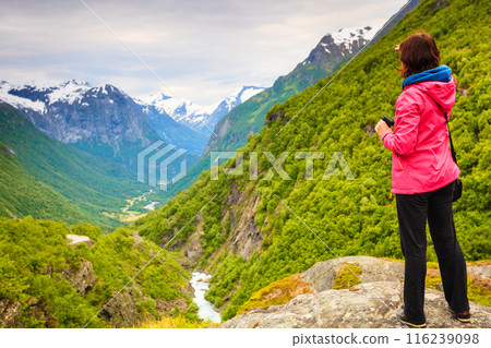 Tourist with camera taking picture in mountains Norway 116239098