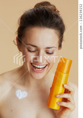 smiling young woman with cosmetic cream jar smiling young woman with cosmetic cream jar 116239152
