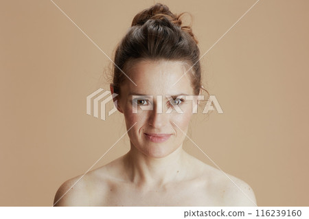 happy young woman isolated on beige 116239160