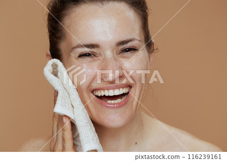 smiling modern female with towel washing face 116239161