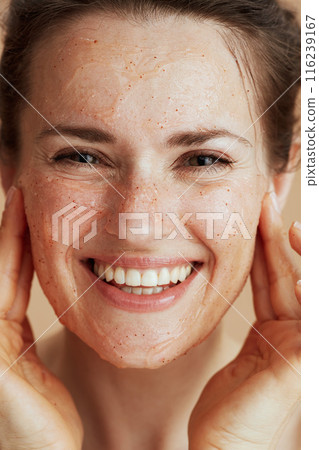 happy young woman with face scrub 116239167