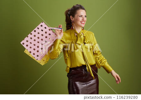 happy fit woman in green blouse against green background happy fit woman in green blouse against green background 116239280