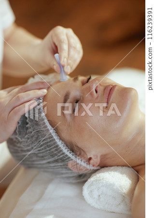 massage therapist in massage cabinet massaging clients face massage therapist in massage cabinet massaging clients face 116239391