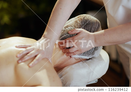 massage therapist in spa salon massaging clients neck massage therapist in spa salon massaging clients neck 116239412