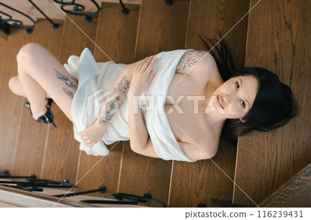 Woman In White Dress Lying On Wooden Stairs Woman In White Dress Lying On Wooden Stairs 116239431