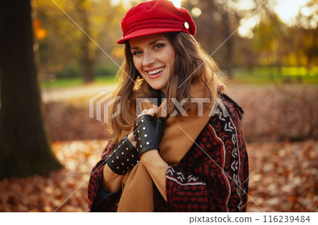 Portrait of smiling trendy 40 years old woman in red hat 116239484