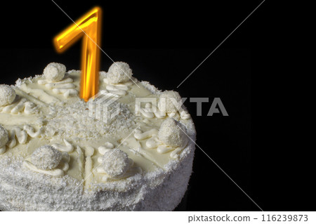 White cake with a golden digit one on a black background 116239873