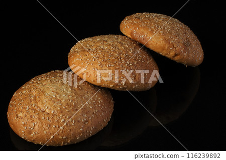 Bread with sesame seeds on a dark background 116239892