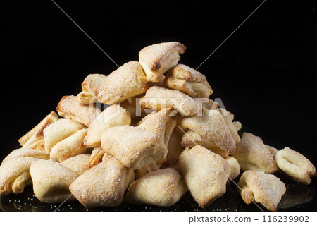 Cookies puff pastry ears on a dark background 116239902