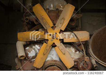 blades on a metal fan on an old rusty piece of mechanism blades on a metal fan on an old rusty piece of mechanism 116240067