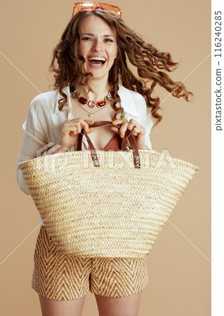 happy elegant housewife in blouse and shorts on beige happy elegant housewife in blouse and shorts on beige 116240285