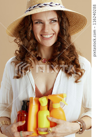 happy elegant woman in blouse and shorts on beige 116240288