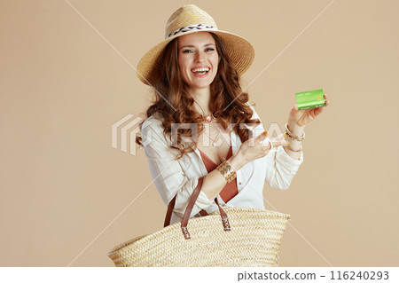 smiling stylish woman in blouse and shorts isolated on beige 116240293