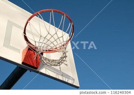 Basketball hoop against blue sky Basketball hoop against blue sky 116240304