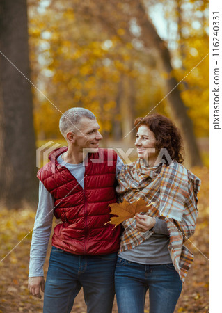 smiling romantic boyfriend and girlfriend in park walking smiling romantic boyfriend and girlfriend in park walking 116240331