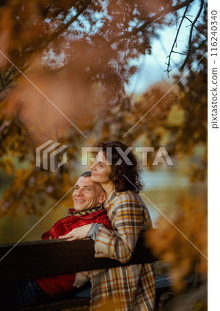 relaxed romantic family in park sitting on bench relaxed romantic family in park sitting on bench 116240340