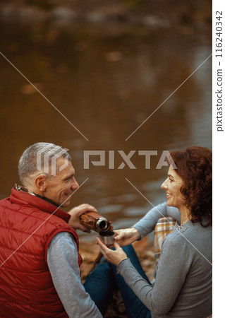 happy modern couple in park with cup of soy latte happy modern couple in park with cup of soy latte 116240342