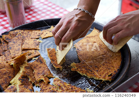Socca, just coming out of the oven, in Nice, the French Riviera. a type of thin, Socca is a specialty of southeastern French cuisine. a pancake made from chickpea flour. Socca, just coming out of the oven, in Nice, the French Riviera. a type of thin, Socca is a specialty of southeastern French cuisine. a pancake made from chickpea flour. 116240349