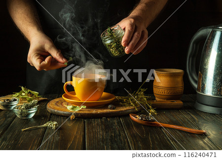 Making medicinal tea from dry herbs. Add dry mint for aroma to a mug of boiling water. The concept of traditional medicine at home 116240471