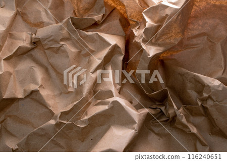 A crumpled craft paper background, symbolizing the essence of recycling - an eco-friendly reminder of reusing and reducing waste, blending sustainability with texture and character. A crumpled craft paper background, symbolizing the essence of recycling - an eco-friendly reminder of reusing and reducing waste, blending sustainability with texture and character. 116240651