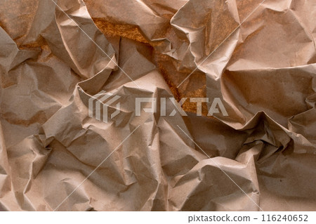 A crumpled craft paper background, symbolizing the essence of recycling - an eco-friendly reminder of reusing and reducing waste A crumpled craft paper background, symbolizing the essence of recycling - an eco-friendly reminder of reusing and reducing waste 116240652