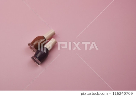 Nail polish small glass bottles on pink background, professional manicure concept Nail polish small glass bottles on pink background, professional manicure concept 116240709