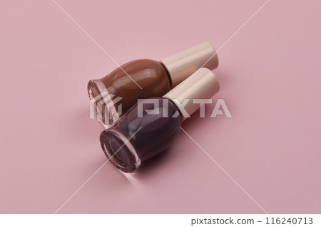 Nail polish small glass bottles on pink background, professional manicure concept 116240713