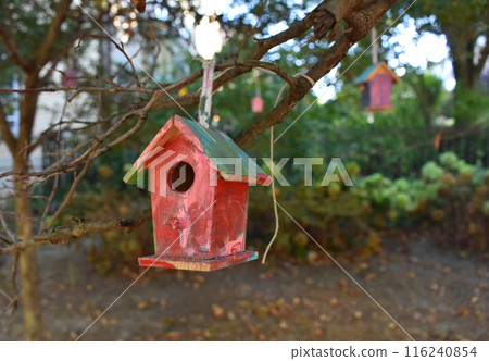 Handmade birdhouse in the garden. Selective focus. nature. Small wooden birdhouse in the park Handmade birdhouse in the garden. Selective focus. nature. Small wooden birdhouse in the park 116240854