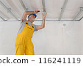 Senior adult worker fixing aluminum batten for gypsum ceiling 116241119