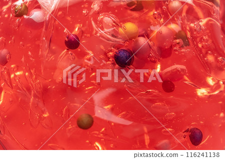 Colorful gel texture, clear skincare cream with bubbles and decorative figurines background, transparent beauty serum, colored cosmetic product close up Colorful gel texture, clear skincare cream with bubbles and decorative figurines background, transparent beauty serum, colored cosmetic product close up 116241138