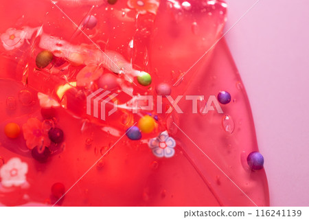 Colorful gel texture, clear skincare cream with bubbles and decorative figurines background, transparent beauty serum, colored cosmetic product close up Colorful gel texture, clear skincare cream with bubbles and decorative figurines background, transparent beauty serum, colored cosmetic product close up 116241139