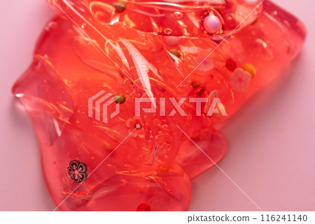 Colorful gel texture, clear skincare cream with bubbles and decorative figurines background, transparent beauty serum, colored cosmetic product close up Colorful gel texture, clear skincare cream with bubbles and decorative figurines background, transparent beauty serum, colored cosmetic product close up 116241140