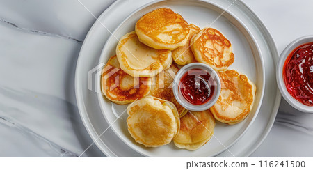 Syrniki (Cottage Cheese Pancakes) on a white marble background, Traditional Russian dessert, Fluffy pancakes made with cottage cheese and served with jam. 116241500