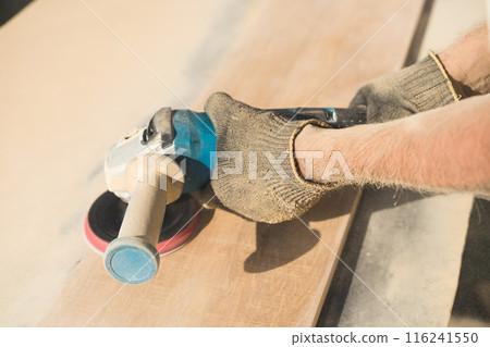 Grinding of an oak board with an angle grinder Grinding of an oak board with an angle grinder 116241550
