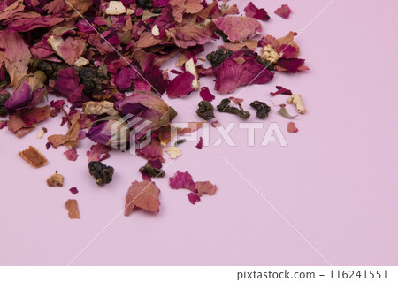 Dried rose petals on a pink background, purple rose flowers close-up, romantic floral texture Dried rose petals on a pink background, purple rose flowers close-up, romantic floral texture 116241551