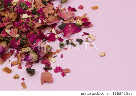 Dried rose petals on a pink background, purple rose flowers close-up, romantic floral texture Dried rose petals on a pink background, purple rose flowers close-up, romantic floral texture 116241552