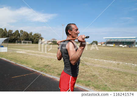 Athlete Using A Bar To Stretch Athlete Using A Bar To Stretch 116241574