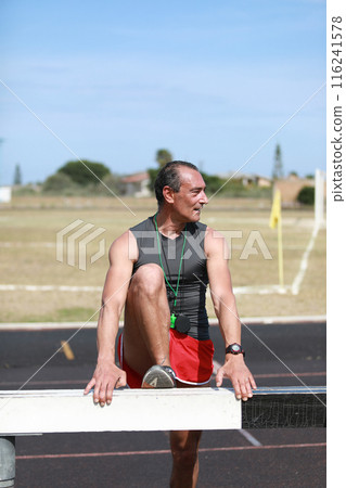 Athlete Recovering Legs On Small Wall Athlete Recovering Legs On Small Wall 116241578