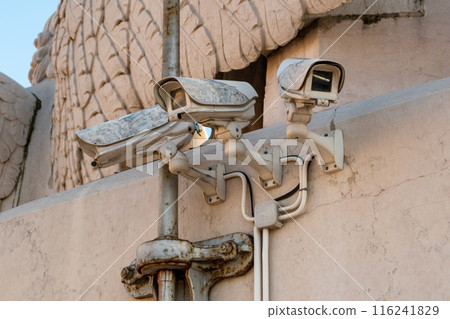 Surveillance cameras on the wall, multiple security cameras 116241829