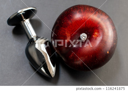 Anal sex concept, anal plug on a black background, butt plug with blue rhinestone, sex toy 116241875
