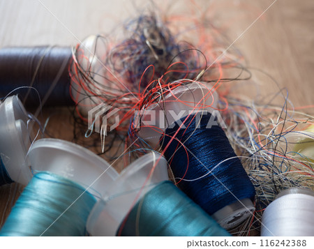 Spools of colored embroidery threads. Huge knot is haphazardly braided. Extreme macro. Beautiful story for intro. Title credits. Abstract screensaver. Handicraft entropy concept. Disorder measure Spools of colored embroidery threads. Huge knot is haphazardly braided. Extreme macro. Beautiful story for intro. Title credits. Abstract screensaver. Handicraft entropy concept. Disorder measure 116242388