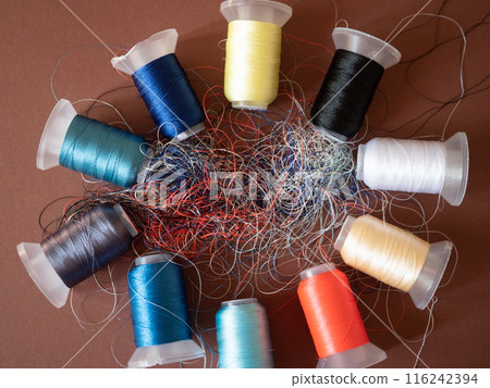 Spools of colored embroidery threads. Huge knot is haphazardly braided. Extreme macro. Beautiful story for intro. Title credits. Abstract screensaver. Handicraft entropy concept. Disorder measure Spools of colored embroidery threads. Huge knot is haphazardly braided. Extreme macro. Beautiful story for intro. Title credits. Abstract screensaver. Handicraft entropy concept. Disorder measure 116242394