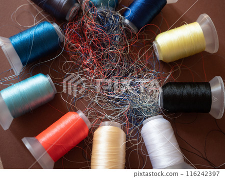 Spools of colored embroidery threads. Huge knot is haphazardly braided. Extreme macro. Beautiful story for intro. Title credits. Abstract screensaver. Handicraft entropy concept. Disorder measure 116242397