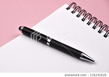 Black pen and notepad on a pink background, notebook with blank sheet 116242626