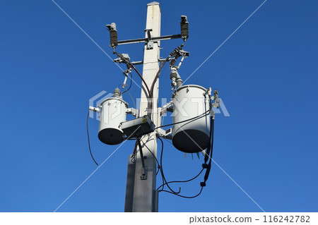Power transformers on a pole to power the building 116242782