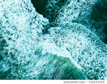 Overhead view turquoise stormy ocean waves with white foam in the ocean,Sea water with splashes and foam, Top view waves background, Natural background photo sea texture with waves soft focus 116243329