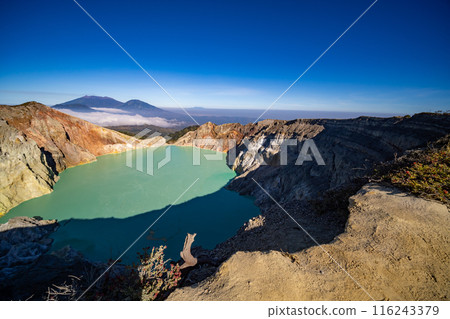 Aerial view Kawah Ijen volcano with turquoise sulfur water lake at sunrise.Amazing nature landscape view at East Java, Indonesia. Natural landscape background 116243379