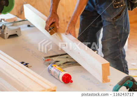 Carpenter working at a new house construction site (planing) 116243717